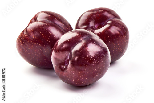 Fresh juicy red plums, isolated on white background