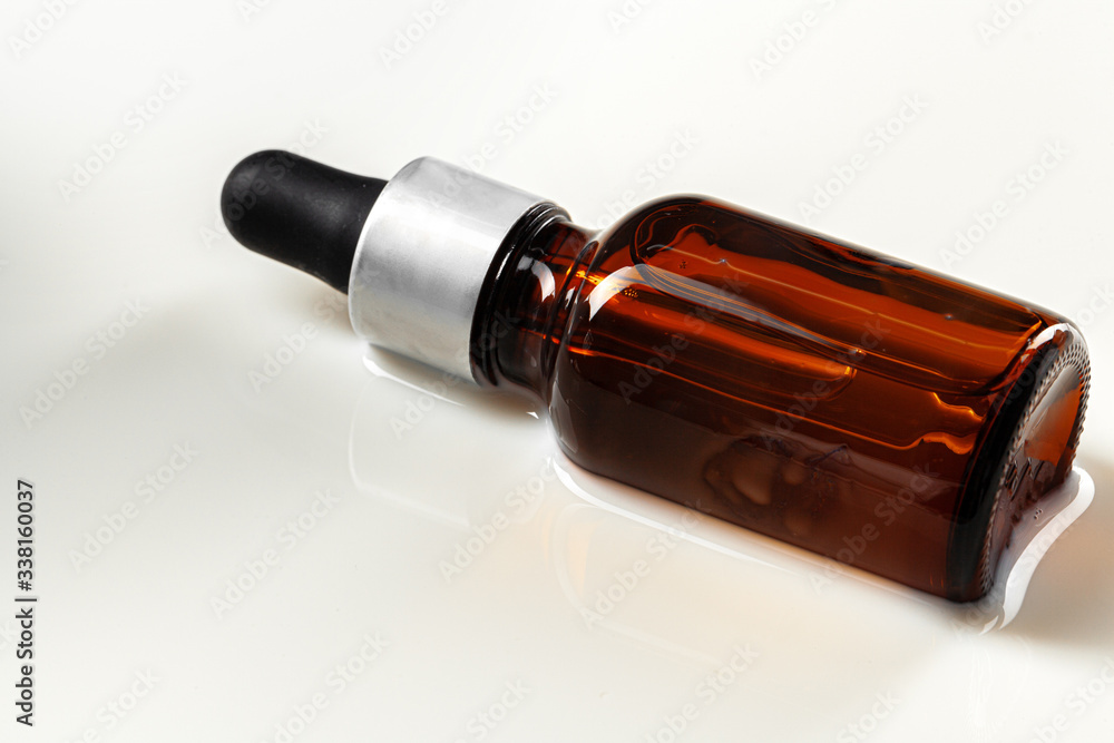 Skincare serum bottle on a light beige background close up Skincare serum bottle on a light beige background close up