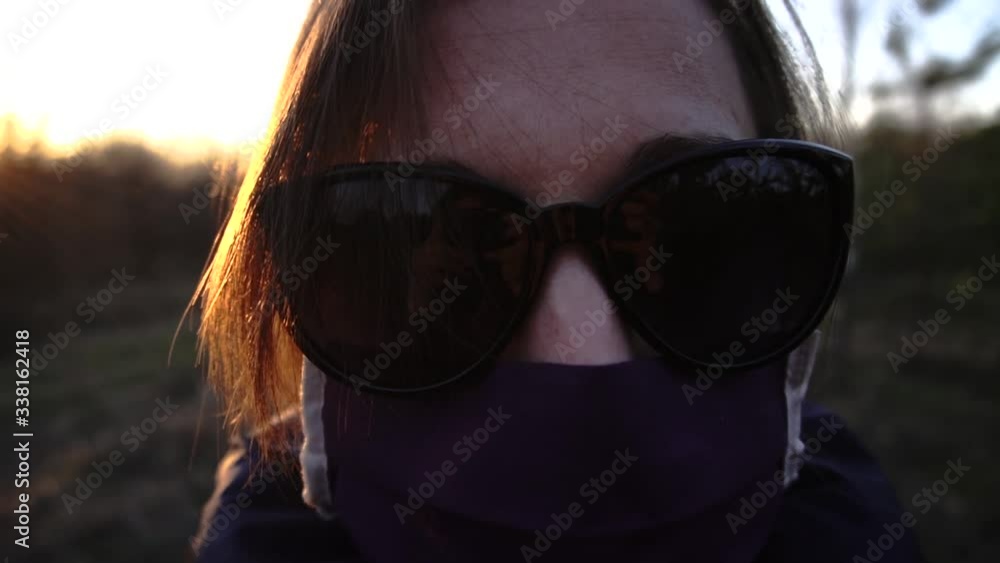 girl alone without people in a protective mask from coronavirus in sunglasses at sunset girl alone without people in a protective mask from coronavirus in sunglasses at sunset