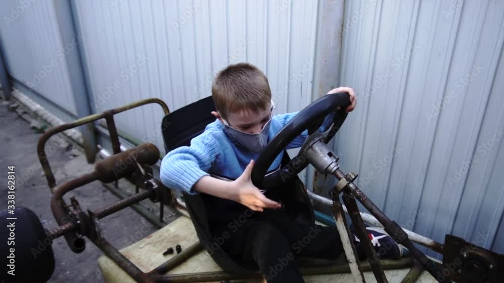 a child at home in quarantine plays unfinished go-kart for him in masks against the virus a child at home in quarantine plays unfinished go-kart for him in masks against the virus