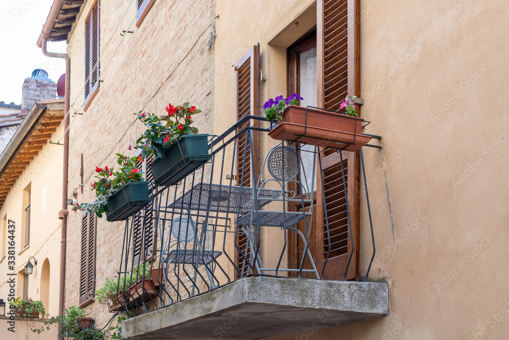 romantic balcony with flowers in the streets of Tuscany