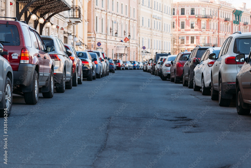Cars parked on a street in a European city on Sunny summer day