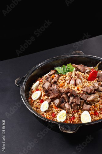 Vertical shot of pilaf. Traditional Uzbek dish plov. Same like biryani in India. Family portion. Best concept for promotion