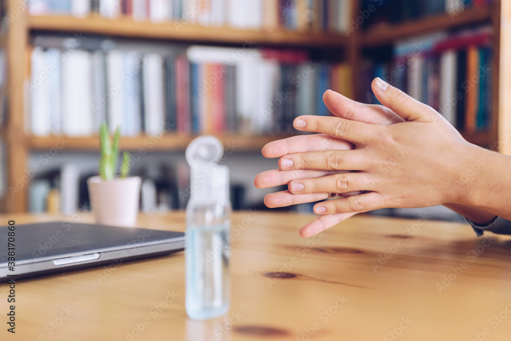 Coronavirus concept. Girl working from home put antiseptic gel on her hands for protection from coronavirus. Global call to stay home. Coronavirus concept. Girl working from home put antiseptic gel on her hands for protection from coronavirus. Global call to stay home.