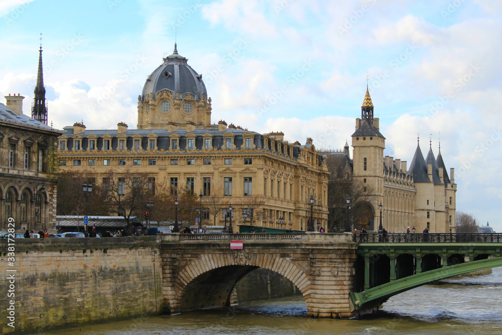 View of the old stone buildings with towers and a bridge over the River Seine.