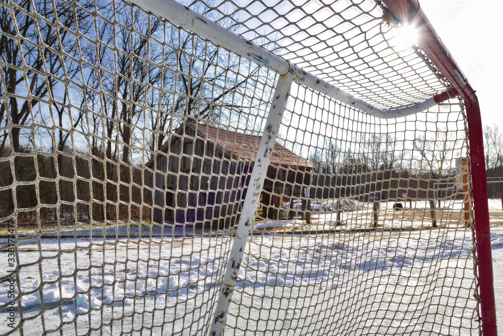 Sunlight on the hockey goal nets  in the rural park in winter