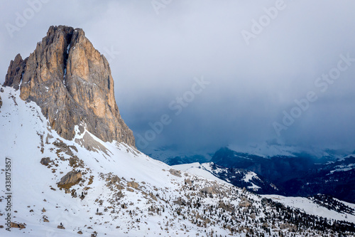 Top of the cliff in the fog. Dolomiti mountain landscape at a ski resort Campitello di Fassa Italy.