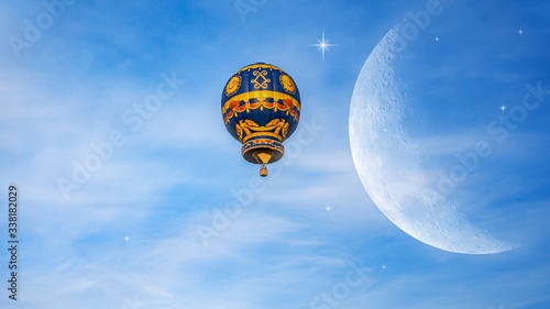 Obraz na płótnie Moon in bright clouds of sunset sun . New moon , moon in the blue sky new moon in the clouds . Balloon flies to stars w salonie