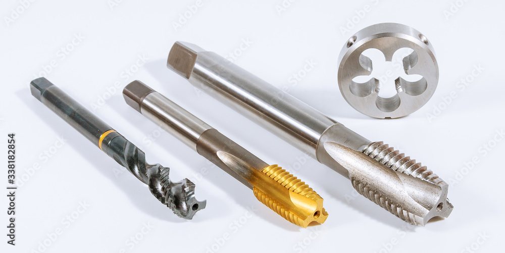 Tap for threading in metal on white background. Tool for metal processing. Tap for threading in metal on white background. Tool for metal processing.