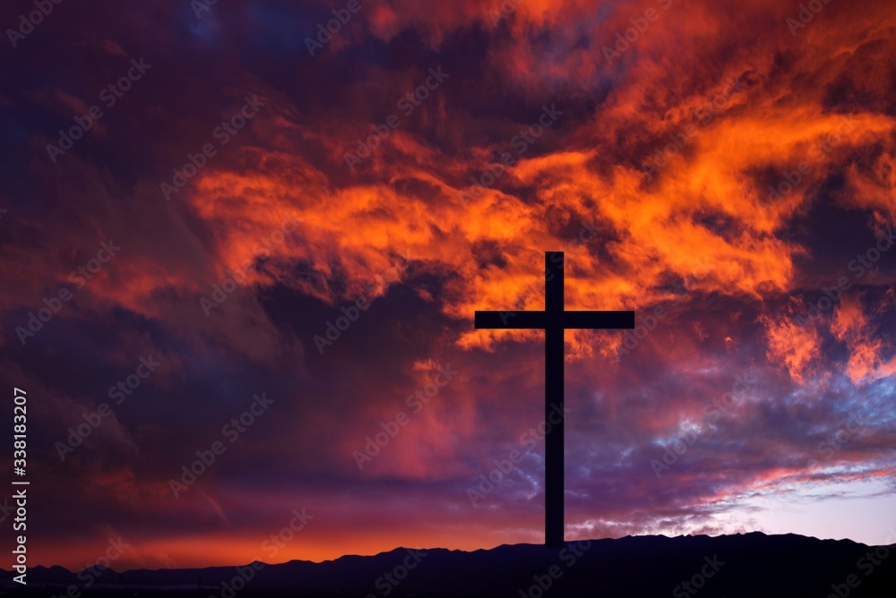 Wooden cross against sky background   , Easter background. Christian cross against celestial clouds. 