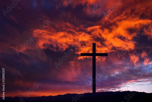 Wooden cross against sky background , Easter background. Christian cross against celestial clouds. 