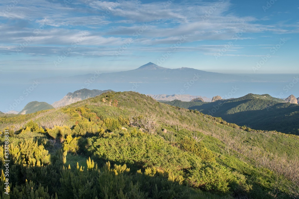 View of Teide and Tenerife over the rugged landscape of La Gomera