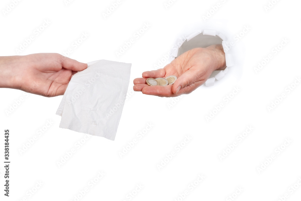 Hand buys toilet paper from the other hand through hole in the wall Hand buys toilet paper from the other hand through hole in the wall