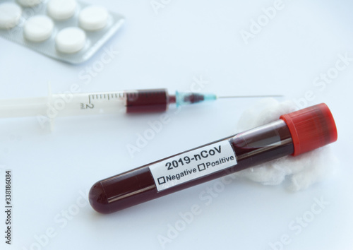 New coronavirus blood test, pills, syringe and needle on white background. Close up. Isolated