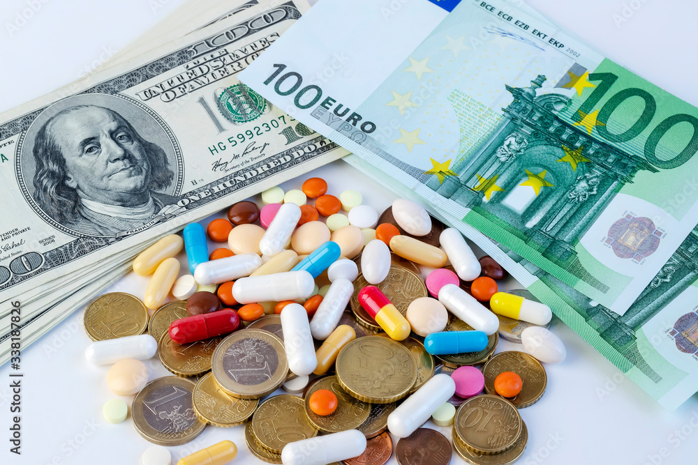 Different pills on a background of dollar and euro cash, conceptual image.Covid - 19 Different pills on a background of dollar and euro cash, conceptual image.Covid - 19