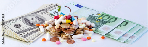 Different pills on a background of dollar and euro cash, conceptual image.Covid - 19