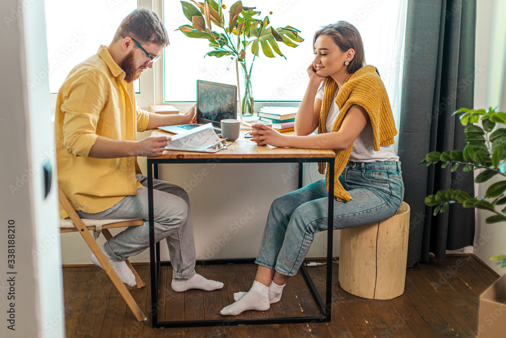 cute caucasian wife look at working husband with love, married couple at home. man sit using laptop, at freelance cute caucasian wife look at working husband with love, married couple at home. man sit using laptop, at freelance
