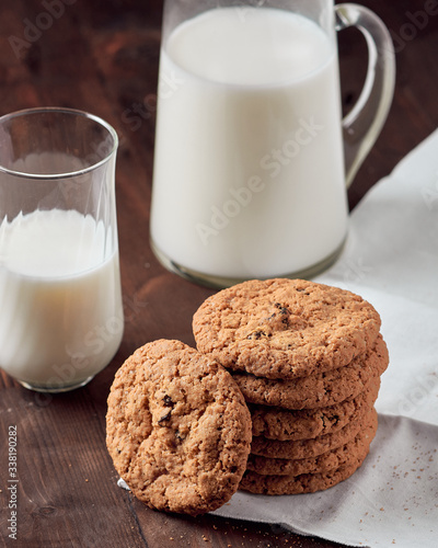 Oatmeal cookies on a wooden table with a glass of milk. breakfast concept