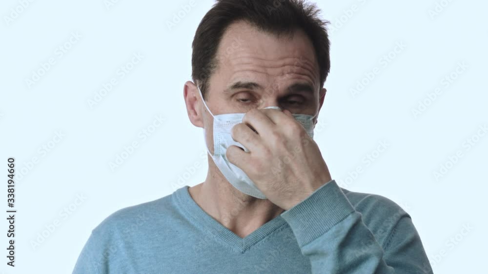 Man puts on medical mask against virus infections. Studio white background Man puts on medical mask against virus infections. Studio white background