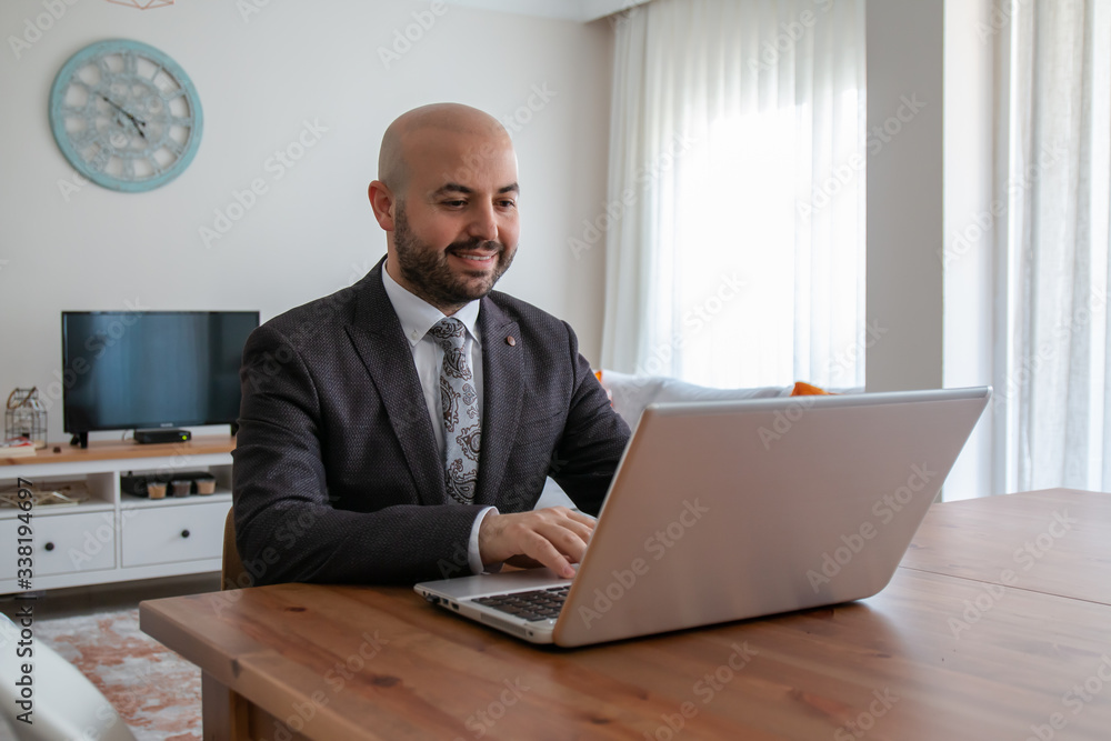 Confident businessman with beard in suit doing job interview with leptop at home. Confident businessman with beard in suit doing job interview with leptop at home.