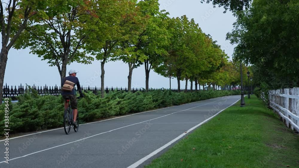 This video showcases a single cyclist riding along a bike path in an urban park.
This video showcases a single cyclist riding along a bike path in an urban park.
