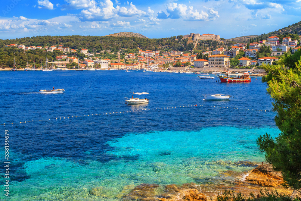 Coastal summer landscape - view of the town of Hvar and the Spanish fortress above it, on the island of Hvar, the Adriatic coast of Croatia