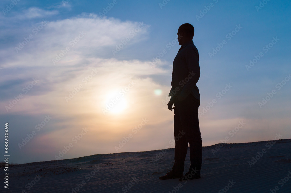 silhouette photo of guy at sunset time on sky background