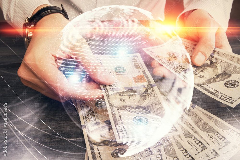 Multi exposure of financial theme drawing hologram and USA dollars bills and man hands. Business concept. Multi exposure of financial theme drawing hologram and USA dollars bills and man hands. Business concept.