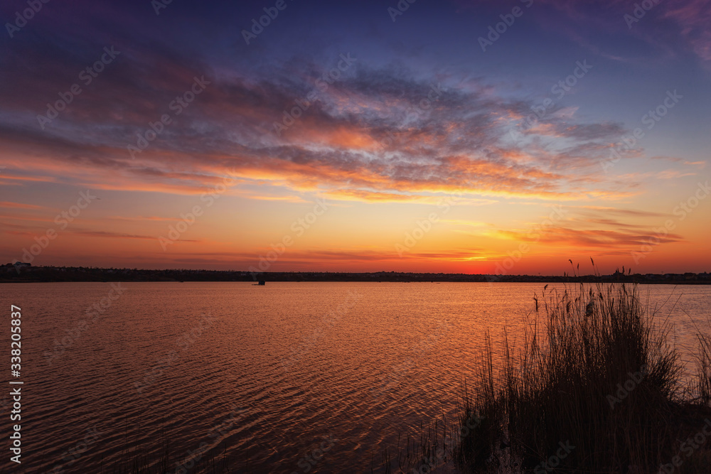 Beautiful sunset on the lake with clouds and reflections on the water Beautiful sunset on the lake with clouds and reflections on the water