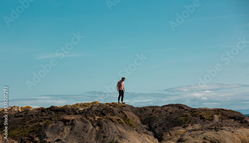 Man on rocks on Scottish coast