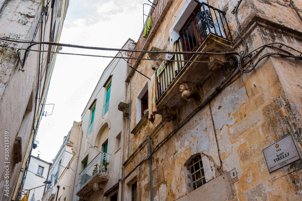  Old town street view in Altamura, Apulia, Italy. Via Mario Tirelli or Mario Tirelli Street partial low-angle high section view with decoration