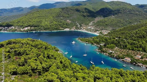 Aerial view of the Panormos. Beach, sea, sail boats and the forest in the background. Summer in Skopelos, Greece