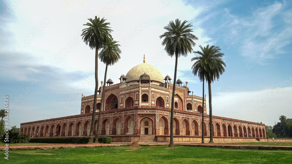 wide view of humayuns tomb and palm trees in delhi, india