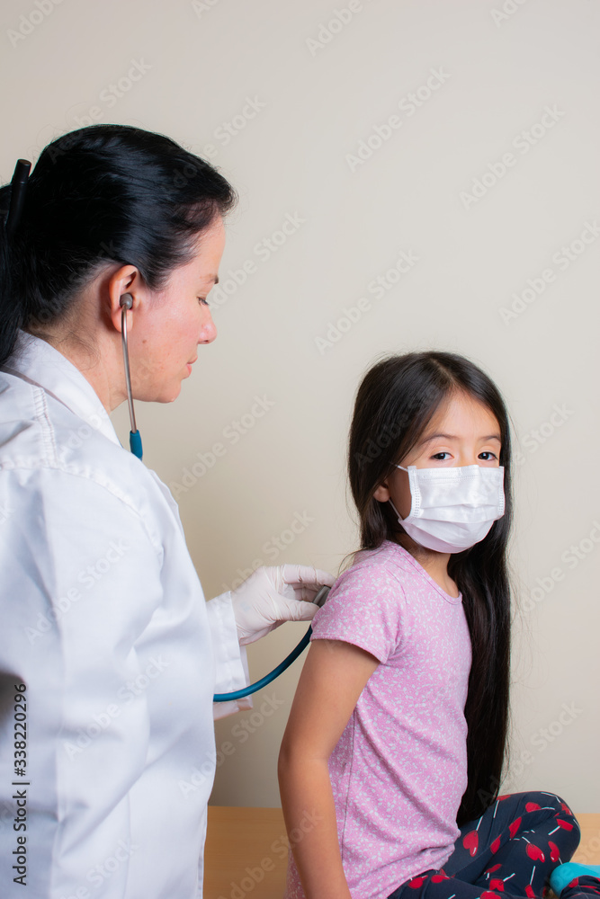 Colombian girl is examined by her pediatrician in the consulting room Colombian girl is examined by her pediatrician in the consulting room