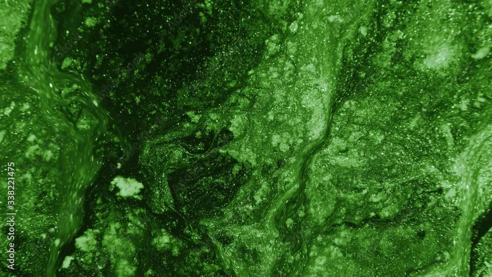 Fluid art. Toxic acid. Glitter green liquid paint flow motion creative background. Fluid art. Toxic acid. Glitter green liquid paint flow motion creative background.