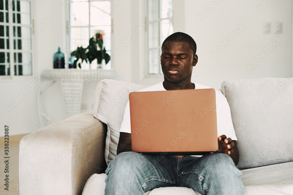 man sitting on sofa with laptop man sitting on sofa with laptop