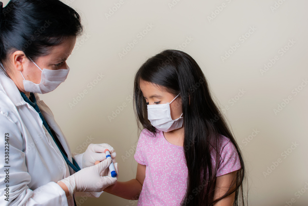 Colombian girl is examined by her pediatrician in the consulting room Colombian girl is examined by her pediatrician in the consulting room