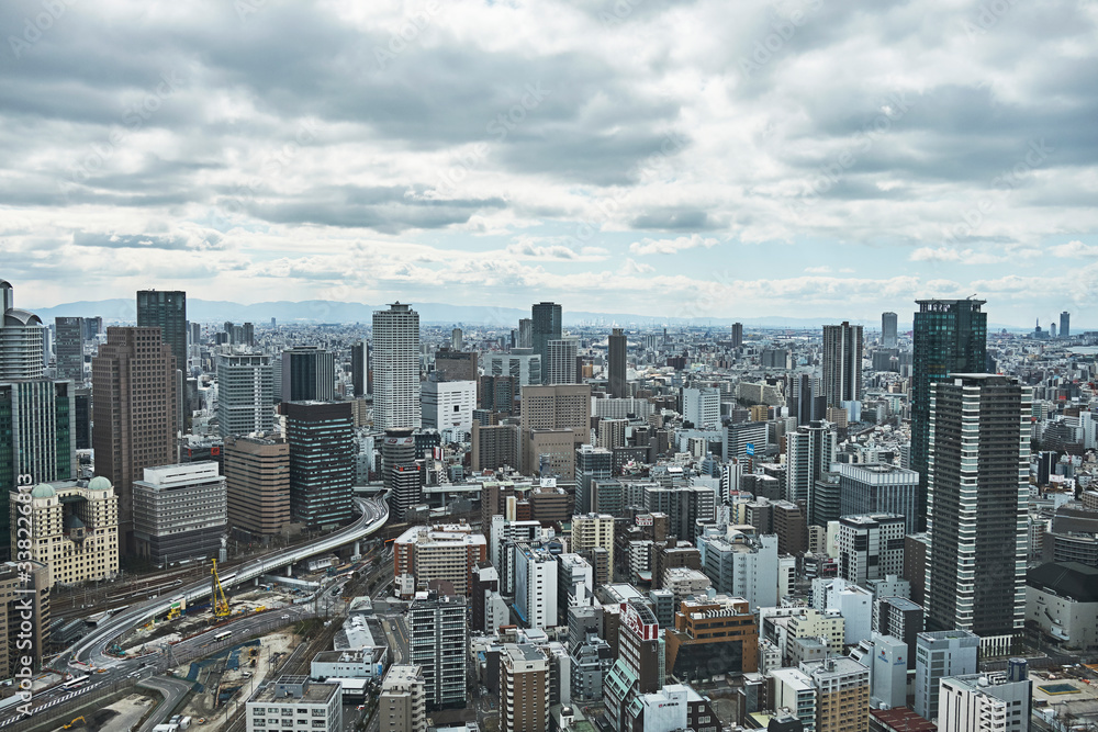 Fototapeta premium Osaka Skyline from High Viewpoint, Dense City Under Overcast Sky