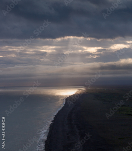 Sun shining through clouds on the coast  landscape in Vik  Iceland