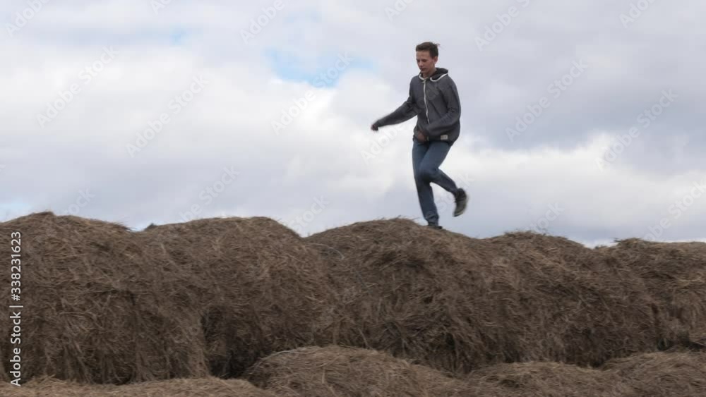 child play with a stack of straw against the sky child play with a stack of straw against the sky