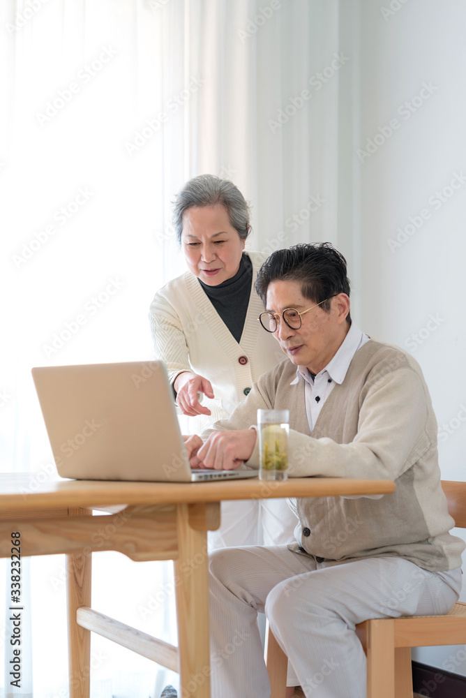 An Asian elderly couple using a computer An Asian elderly couple using a computer