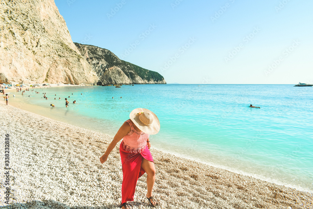 Beautiful woman walking on Porto Katskiki beach in Greece Beautiful woman walking on Porto Katskiki beach in Greece