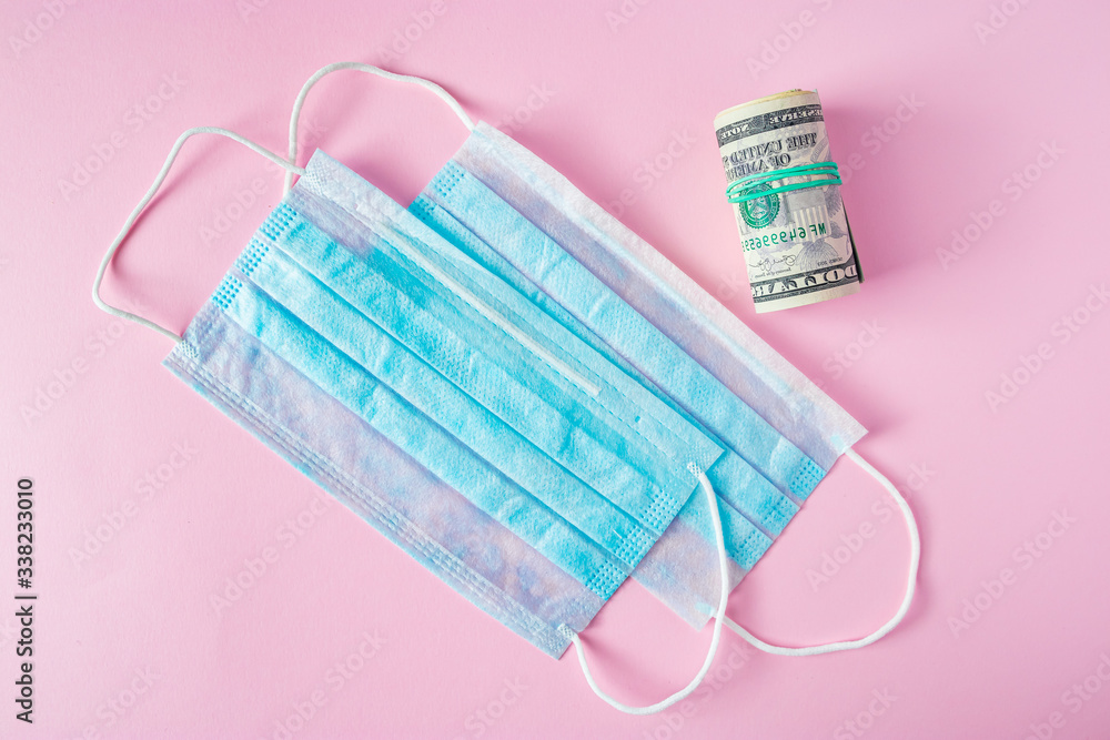 Medical mask and money. Buying protective respirators from the coronavirus. Illegal sale of surgical face masks. Medical mask and money. Buying protective respirators from the coronavirus. Illegal sale of surgical face masks.