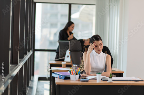 Stressed business woman with palm on face in her office