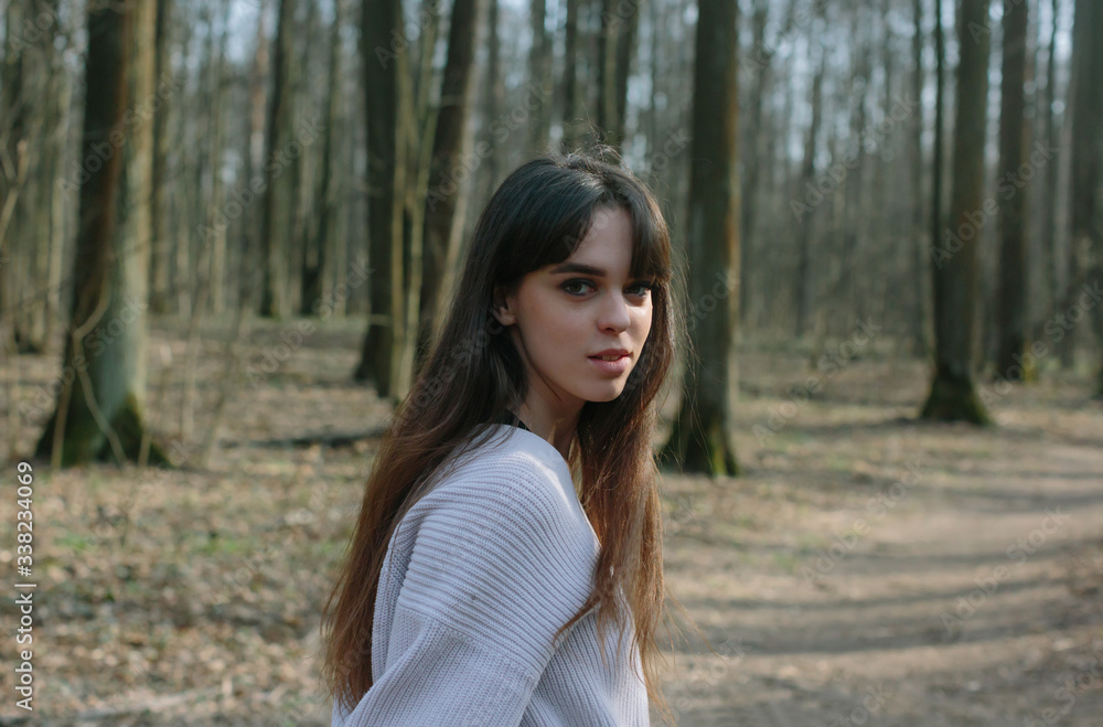 young smiling woman turning back on forest walk young smiling woman turning back on forest walk