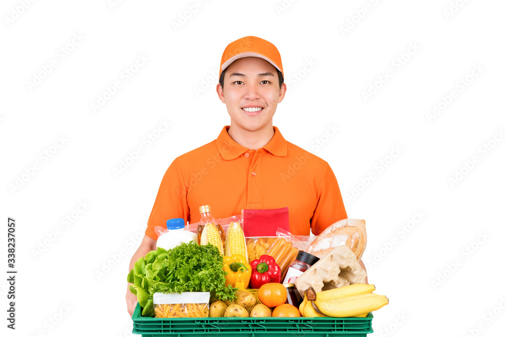 Smiling Asian delivery man in orange uniform holding grocery basket isolated on white background Smiling Asian delivery man in orange uniform holding grocery basket isolated on white background