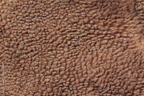 Fur texture of wild animal. Brown fur background. Close up. Fur of brown bear.