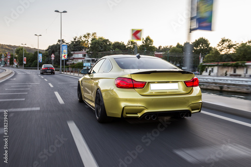 Yellow sedan car on the city roads © azerbaijan-stockers
