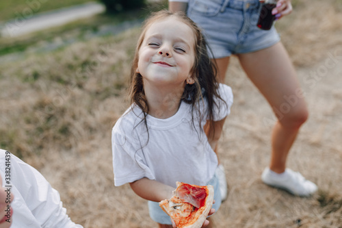 little girl having fun at picnic, pizza, drinks, summer and lawn