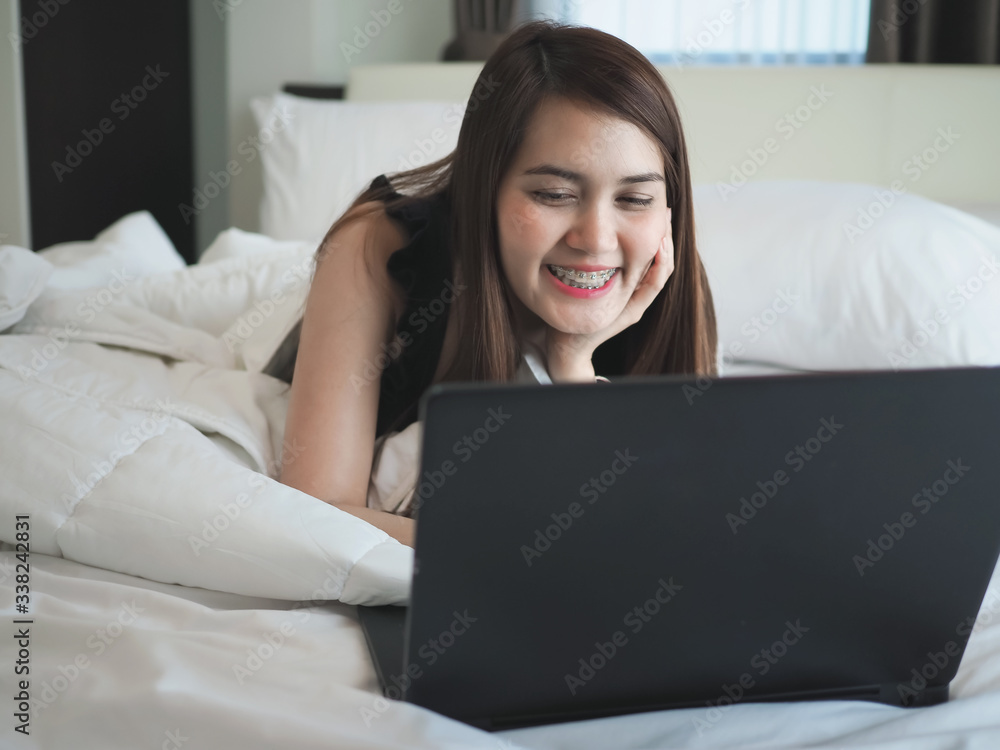 women working on the bed in the morning, in concept of work from home, for stop the spread of the coronavirus or covid-19. women working on the bed in the morning, in concept of work from home, for stop the spread of the coronavirus or covid-19.